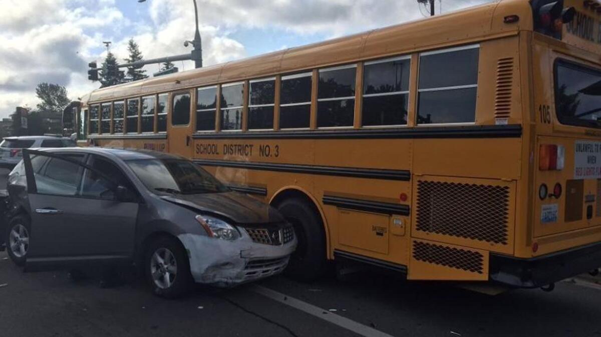 Suspect car next to school bus, which was empty when hit.