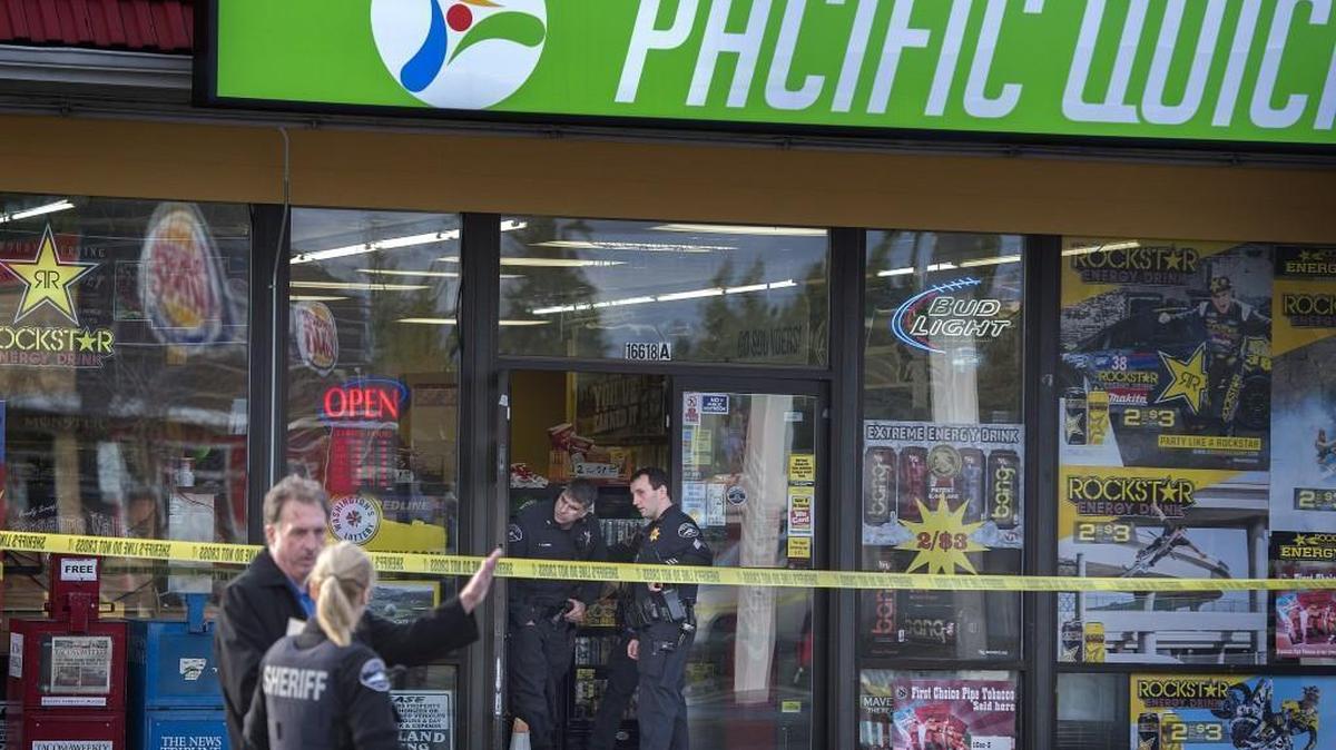 Pierce County Sheriff’s personnel work the scene where a 30-year-old female employee was shot during a robbery at a convenience store in Spanaway on Thursday, Feb. 18, 2016.