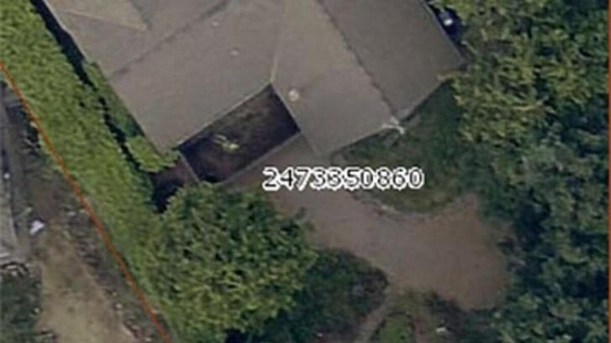 When firefighters responded to a house fire in Renton, they found a body outside the home. Aerial images from King County appear to show that the body was there since at least 2015 and can be seen here as a white figure.