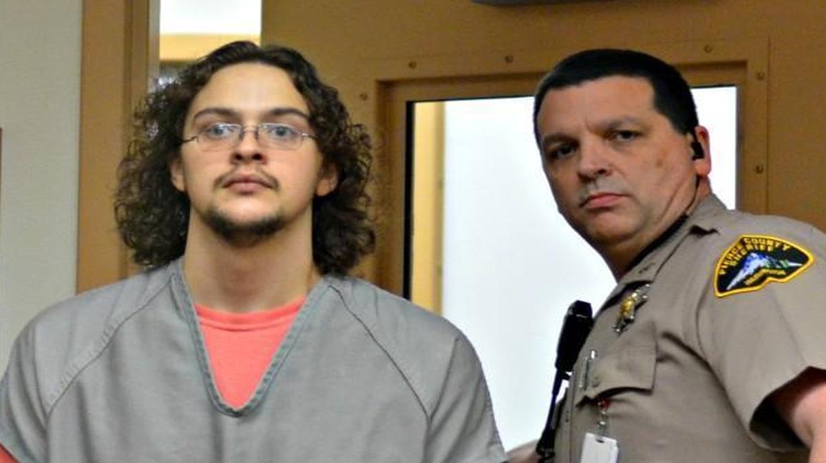 Brett Dollens is led into Pierce County Superior Court for his arraignment Monday.