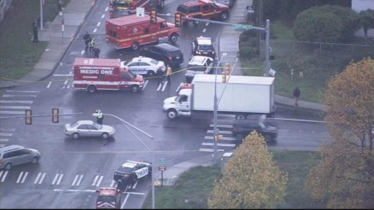 Emergency responders work at the scene of a fatal shooting Thursday near Sea-Tac Airport.