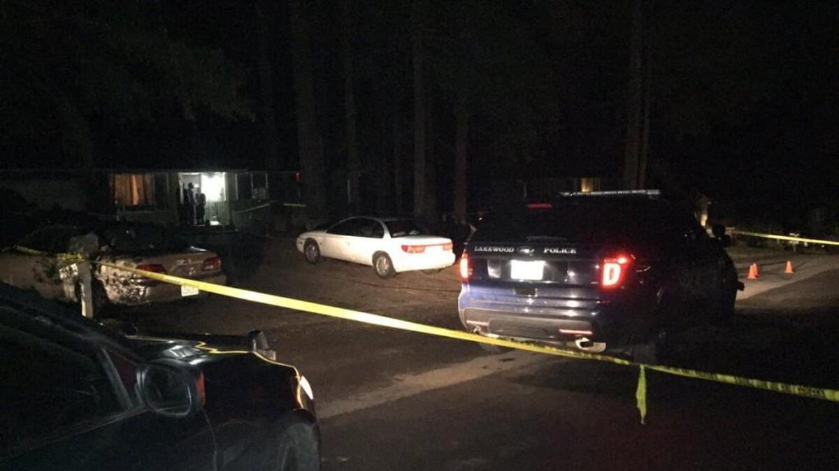 Officer Darrell Moore’s Lakewood police cruiser is parked at the scene of an officer-involved shooting south of Port Orchard early Sunday. Moore shot a man later arrested for unlawful possession of a firearm, according to Kitsap County Superior Court charging documents.