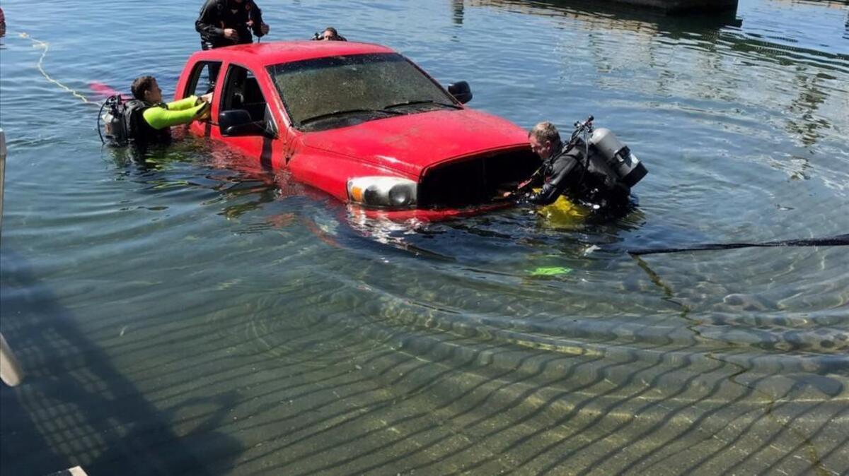 West Pierce Fire & Rescue divers help retrieve a stolen truck they found Friday morning in American Lake.