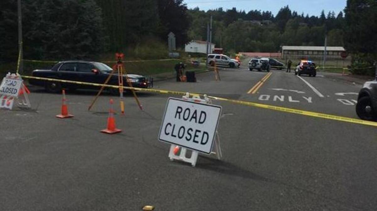 
Police close a street to investigate a crash after a police chase Sunday in Puyallup.
