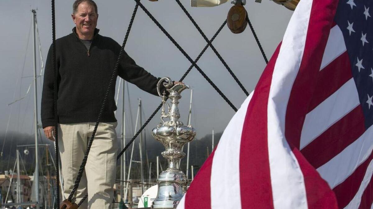 
Troy Sears on the deck of America with the actual America’s Cup during the 34th Amerca’s Cup race in San Francisco in 2013. 
