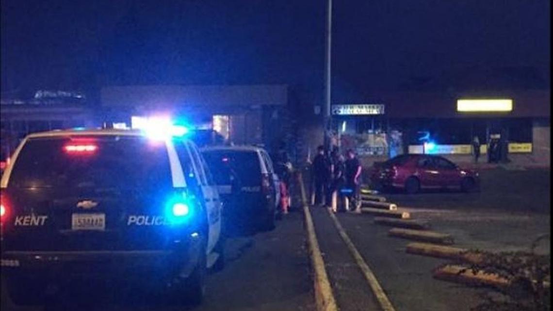 Kent police attend the scene of an officer-involved shooting near the Benson Plaza strip mall in the 23600 block of 104th Avenue Southeast.