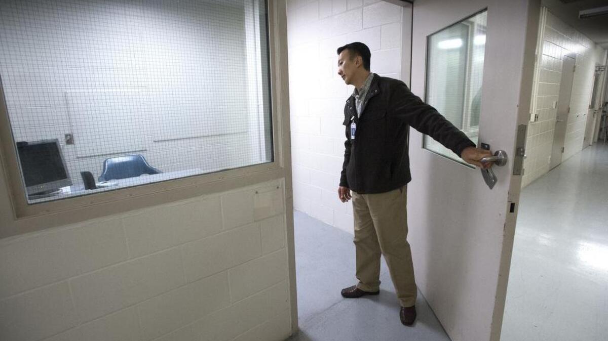 Pierce County Sheriff’s Department mental health director Dr. Lee Wong, hired recently, checks out an interview room for inmates at the Pierce County Jail in Tacoma on Friday.