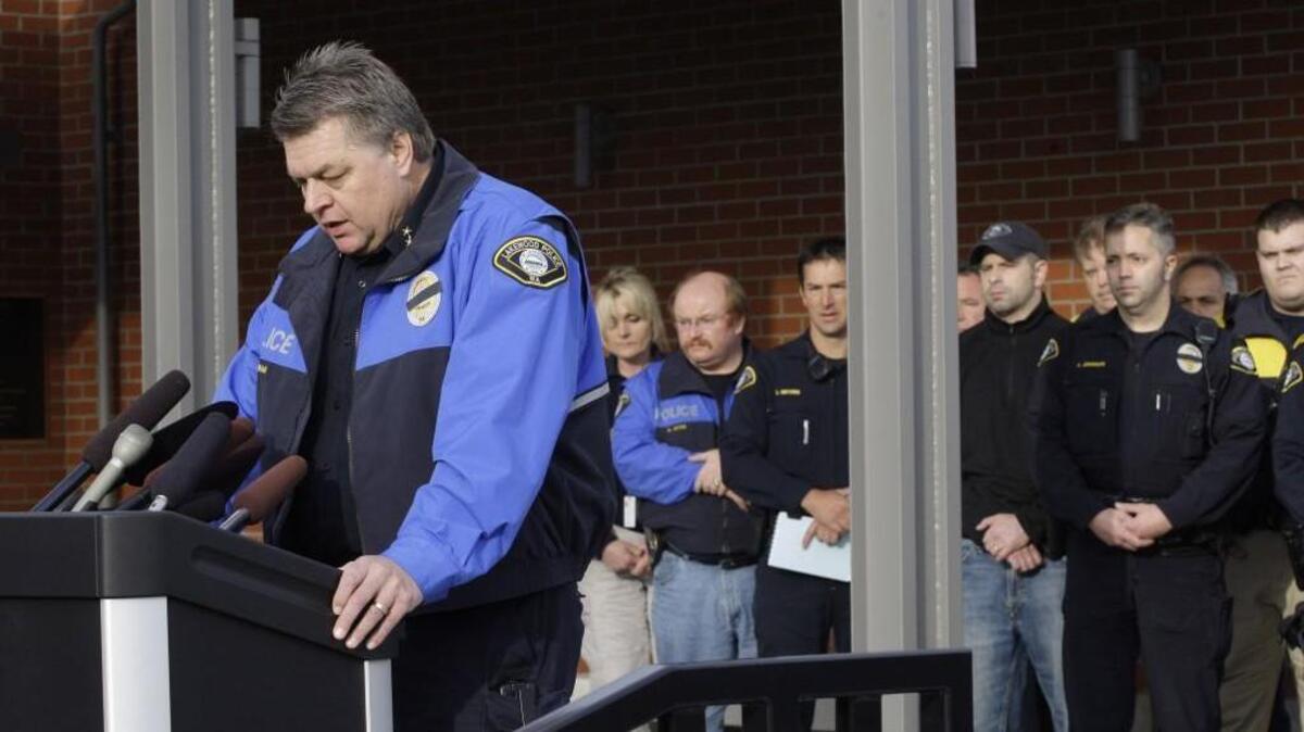 Lakewood Police Chief Bret Farrar, now retired, talks to reporters in 2009 in Lakewood after four officers were fatally shot. He says friendly greetings helped his department after its loss.