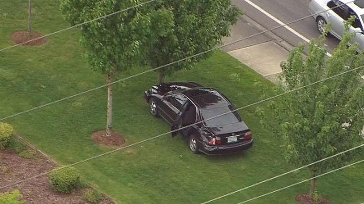 A car sits parked against a tree near Meridian East in South Hill on Thursday afternoon after its occupants fled from Pierce County sheriff’s deputies, sheriff’s spokesman Ed Troyer said.