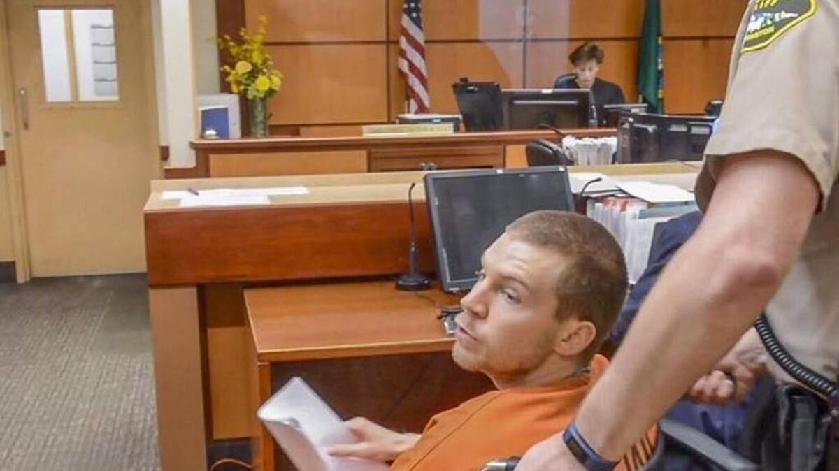 James Reha mouths "love you" to family after being arraigned on charges of second-degree murder and first-degree unlawful possession of a firearm Nov. 23 in Pierce County Superior Court.
