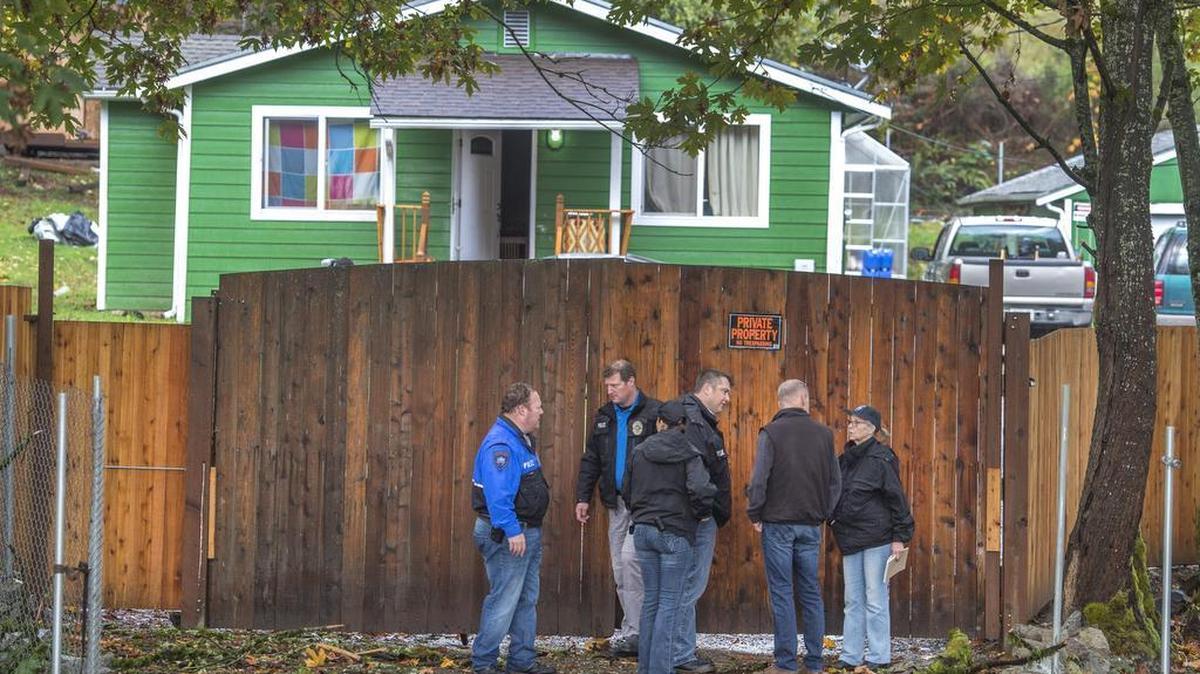 Tacoma police investigate the scene where two men were fatally shot outside a Tacoma home early Friday.