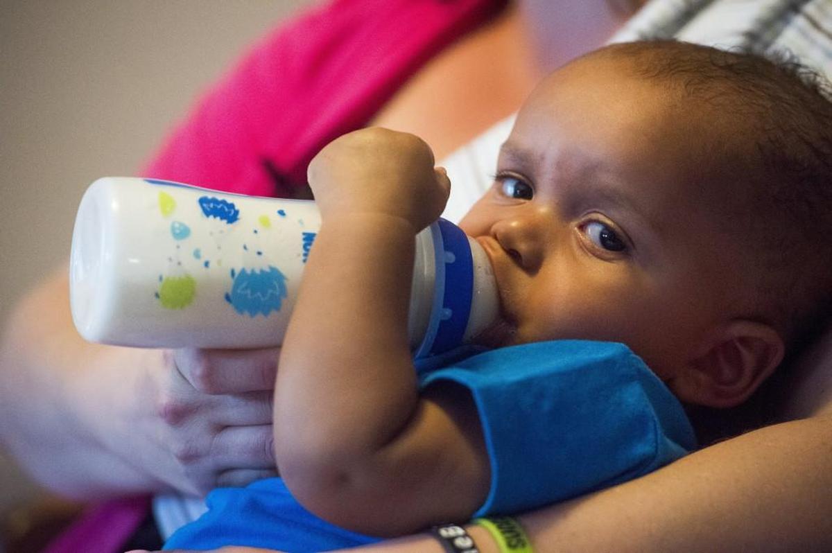 Jacey Harris, 33, plays with her son Jackson, eight months, at Harris' parents home in Puyallup, Wash., on Thursday, Aug. 10, 2017. Jackson was taken from Harris at birth by the state. But since he was 2-months-old, Harris has been able to raise him while getting treatment for addiction and mental health, and having regular check-ins with the court. Harris graduated Baby Court Friday, a Pierce County Superior Court program that aims to get babies into stable, long-term homes as soon as possible. Upon graduation, she regained formal custody.