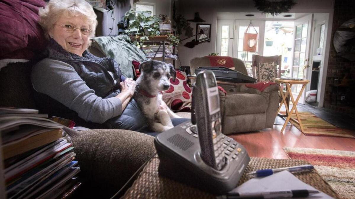 Judith Neilson of Spanaway, seen at home last week with her dog, Missy, got a scam phone call, supposedly from the Pierce County Sheriff’s Department, about missed jury duty.
