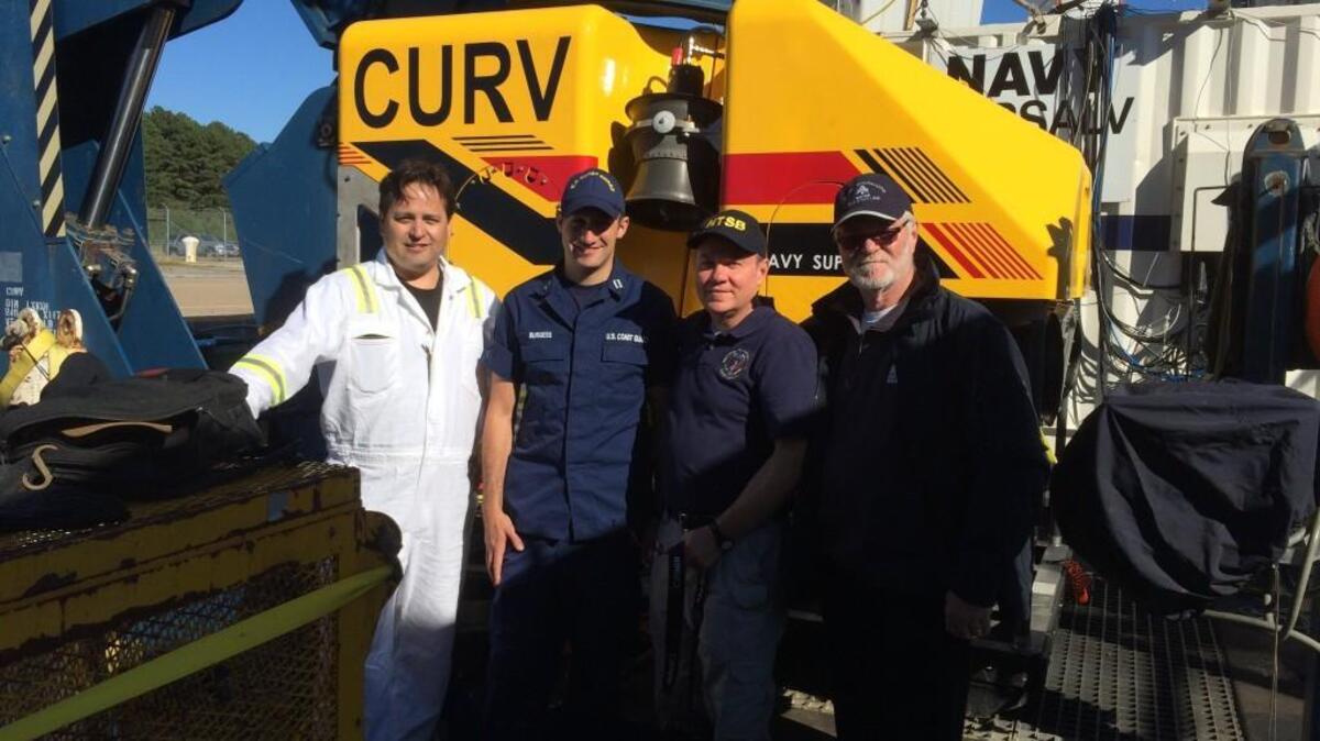 National Transportation Safety Board investigators pose in front of the CURV 21, which is being used to find out what happened to the El Faro.