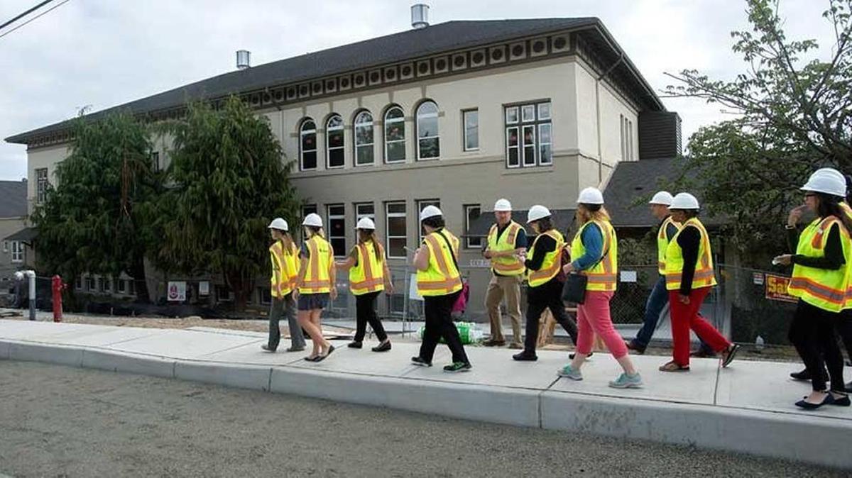 A Korsmo Construction worker leads school employees and parents on a tour of Destiny Middle School in Tacoma in October 2015. Destiny Middle School is one of three charter schools that opened in Tacoma in August 2015.