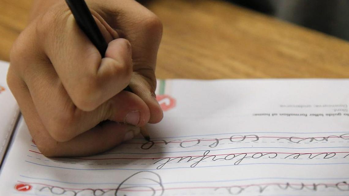 A student practices writing in cursive at St. Mark’s Lutheran School in Hacienda Heights, Calif..