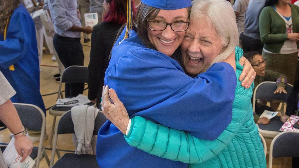 Alyssa Knight, left, gets a happy congratulatory hug from her mom, Sue DuBois after getting her Associate of Arts degree at the Washington Corrections Center for Women in Purdy on Tuesday, June 15, 2016. Knight is the first group to be the first-ever graduation of the Freedom Education Project.