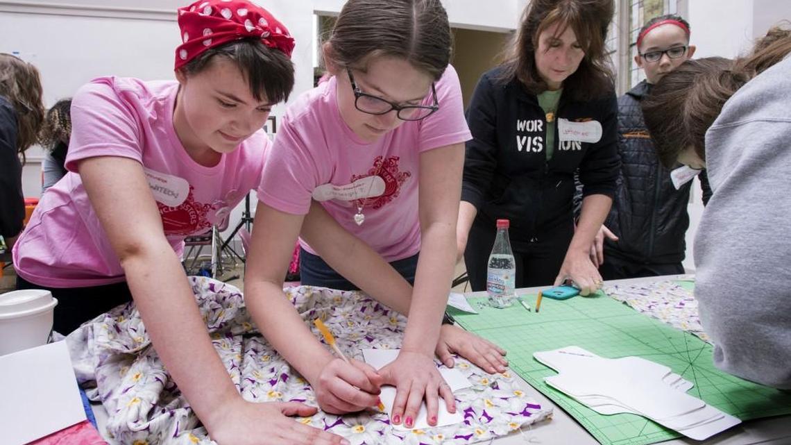 Julia Witecki, 14, left, and Carleigh Templin, 13, draw patterns for reusable pads that will be packaged in menstruation kits for girls in underdeveloped countries. The friends are longtime Girl Scouts who created the Bleedership conference to celebrate menstruation and help their peers realize there’s no shame in having a period. The first Bleedership conference took place Saturday at Trinity Presbyterian Church in Tacoma.