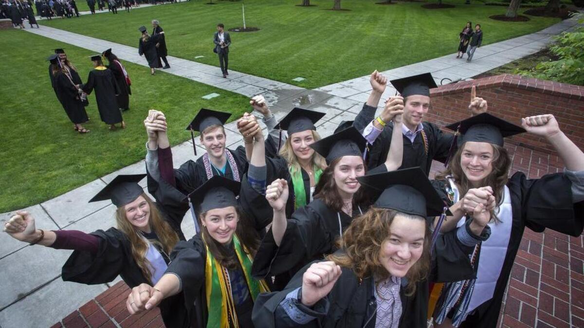 Four set of twins graduating from the University of Puget Sound holding their twin’s hand are Alissa and Joshua Nance, left to right, Nihal and Dina Mustakim, Elaina and Sam Friedman, and Reed and Rachel Glover pose for the photographer and show their happiness at graduating during graduation at University of Puget Sound on Sunday.