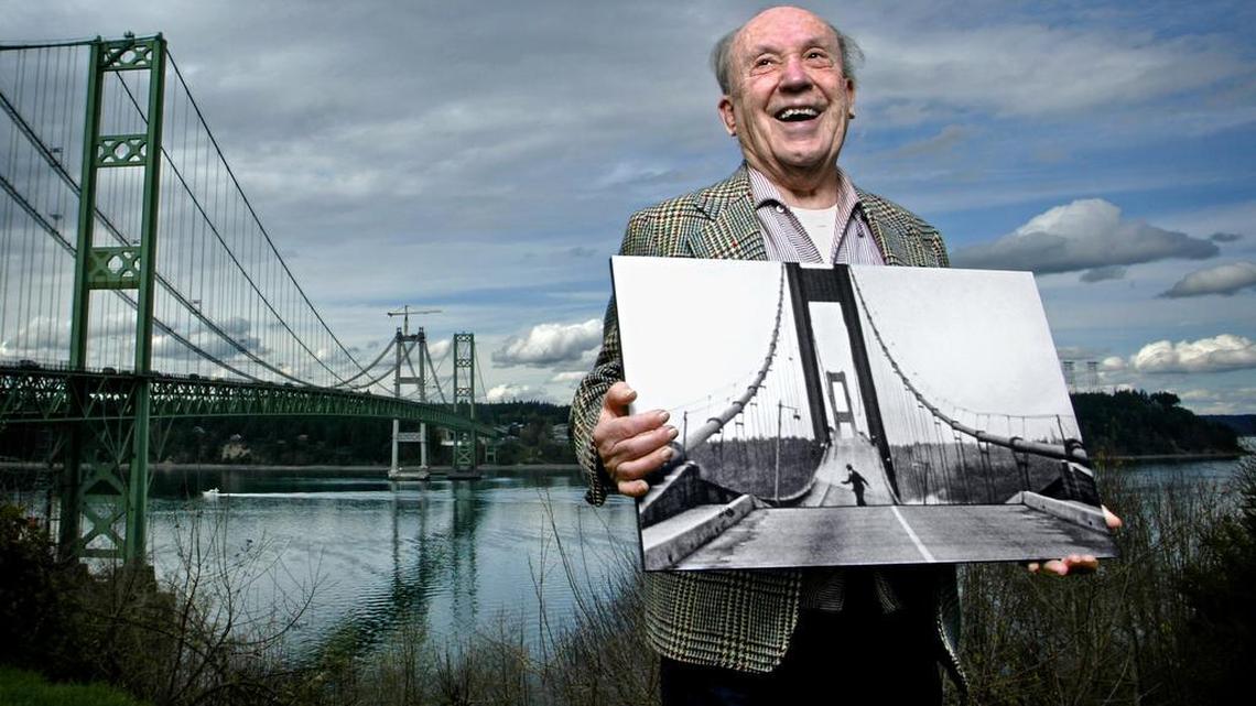Former Tacoma News Tribune photographer Howard Clifford holds an enlargement of a photo that captured him running for his life off the Narrows Bridge, nicknamed “Galloping Gertie,” as it convulsed and broke apart in 40 mile an hour winds on Nov. 7, 1940. Clifford went out on the bridge to get photos and save Tubby, a friend’s dog who was trapped in a car.