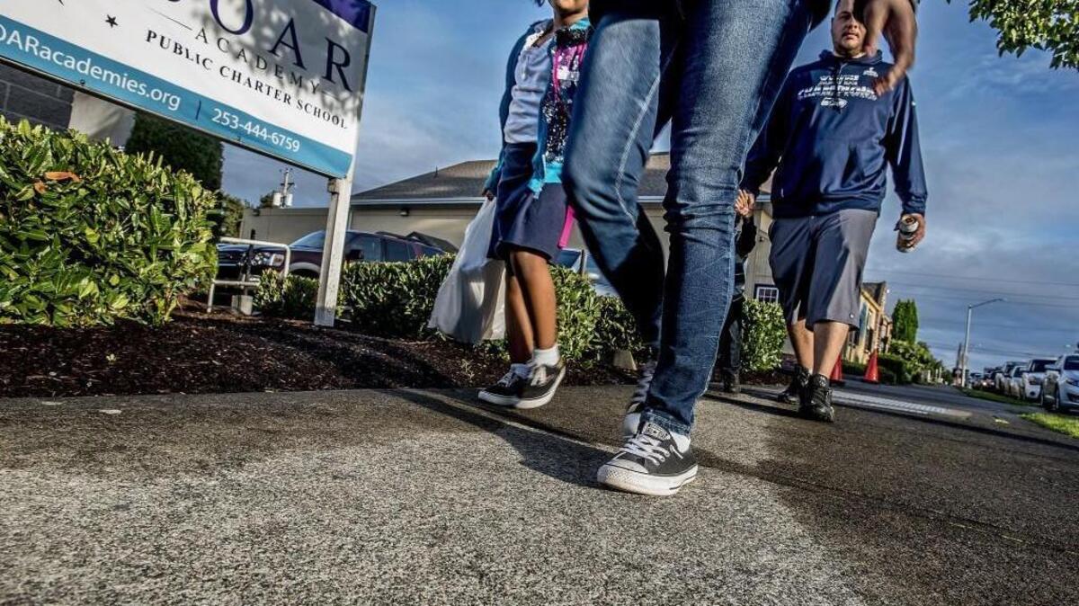 
Alana Thornton, 6, left, holds her mother Jacovia’s hand as they walk to the SOAR Academy, one of three charter schools opening this year in Tacoma. The Washington State Supreme Court ruled 6-3 Friday that the voter-approved charter-school law is unconstitutional. The court said that the privately operated, publicly funded charter schools do not qualify as common schools and thus cannot receive public funding.
