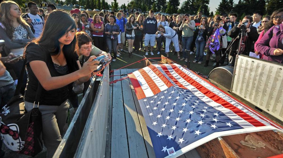 Todd Beamer High School students take photographs in Federal Way of a beam from the World Trade Center during an assembly on the 10-year anniversary of the 9/11 attacks.