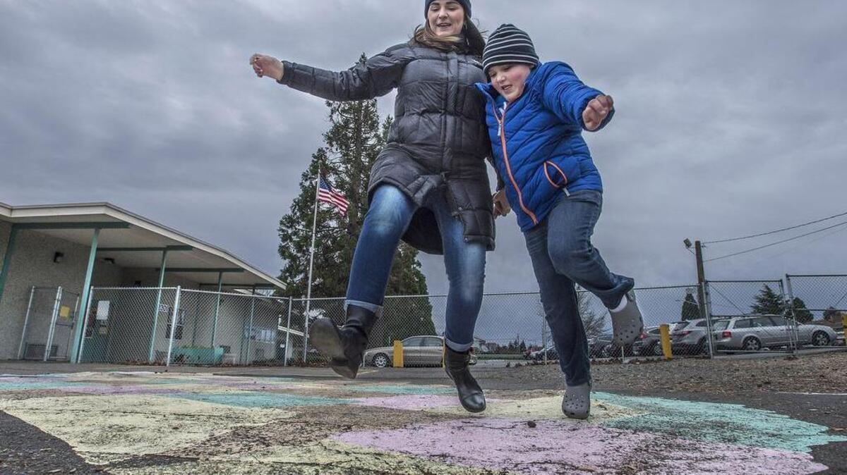 Sue Leusner, mother of 10-year-old Bode, a fourth-grader with autism who attends Tacoma’s Skyline Elementary, is working with other parents of special needs kids in Tacoma to form the Tacoma Special Needs PTA. Leusner and her son enjoy the playground at the school Thursday despite the cold weather.