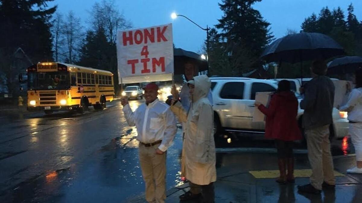 Mohamed El-Sokkary (left) and several other Capital High School parents waved signs before school on Friday, Jan. 29, 2016, in support of a student who says he was unfairly targeted by school officials for organizing an off-campus activity. Students at the school were also planning to hold a sit-in after school in the Commons area.