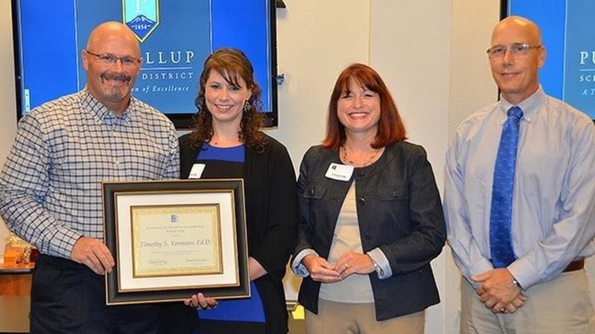 
Tim Yeomans, left, is honored with the national Excellence in Educational Leadership Award. Also present were, from left, University of Washington College of Education representatives Brieanne Hull, Ann O’Doherty and Rob MacGregor.
