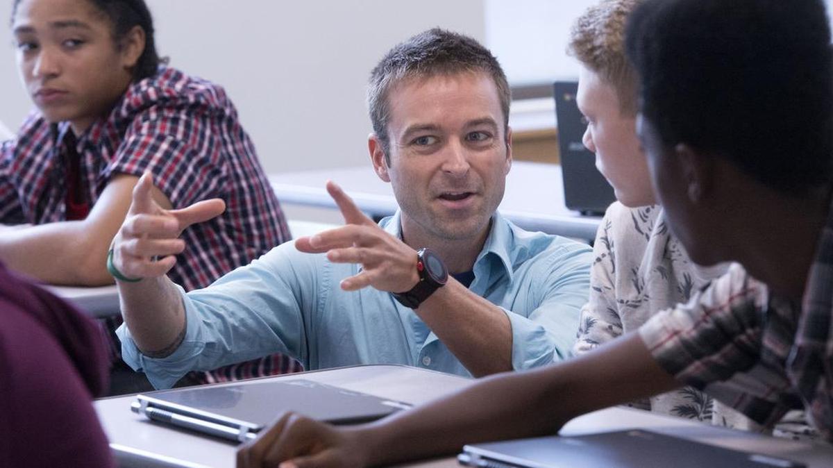 
Math teacher David Dolata, center, helps Tyler Roberts, second from right, and Razel Smith, right, Thursday during an orientation project at Summit Olympus High School in Tacoma. Luis Garcia is at far left.
