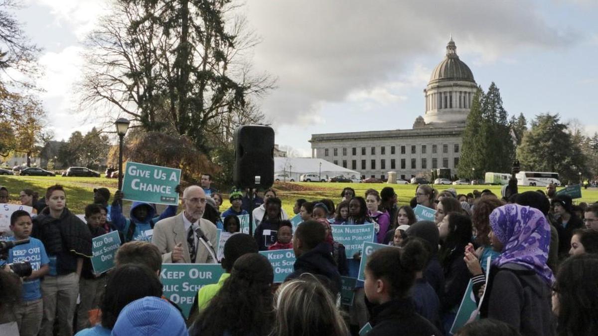 Democratic state Rep. Larry Springer, left, speaks to supporters of state charter schools during a rally in front of the Capitol in Olympia, Wash., on Thursday, Nov. 19, 2015.