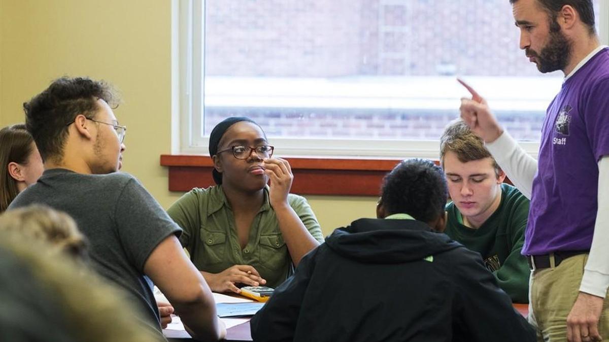 Nia Hall listens to teacher Ian Sample, right, in her calculus class at Garfield. Hall wants to go to one of the nation’s historically black colleges, and then attend law school. Her teachers say she’s very smart and highly motivated.
