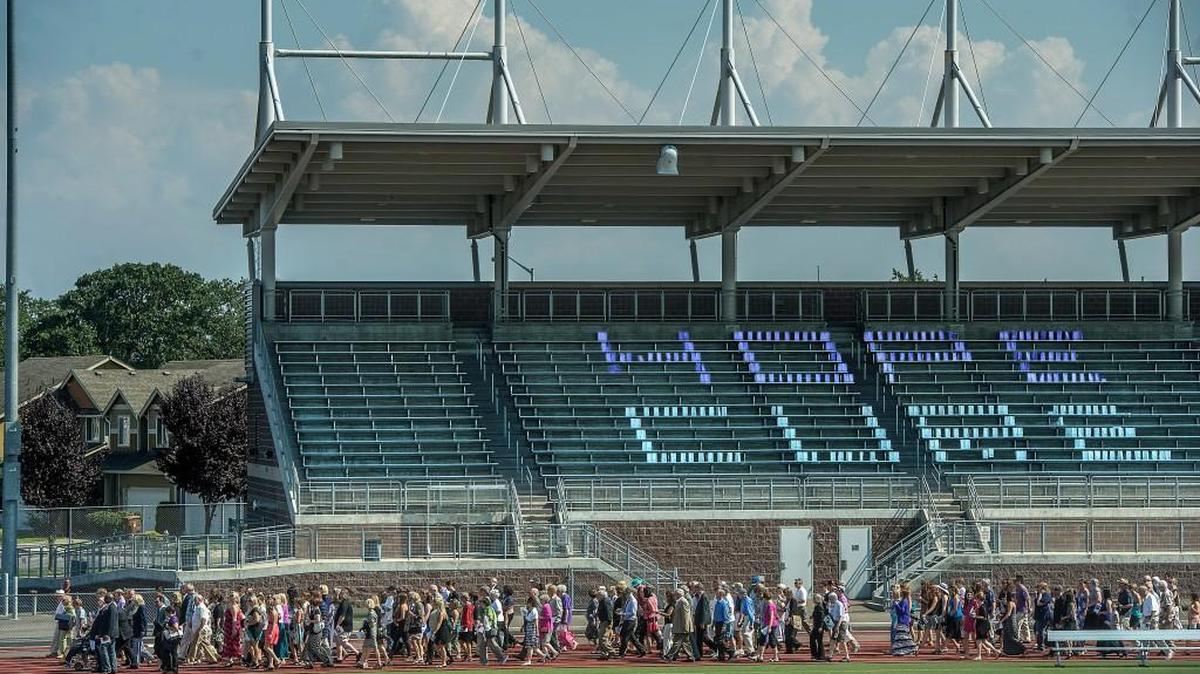 Hundreds honored the life of Relay for Life founder Dr. Gordon Klatt with a last lap around the track at Mount Tahoma High School in 2014. This year, teachers are upset about a scheduling conflict between the cancer fundraiser and an elementary school track meet.