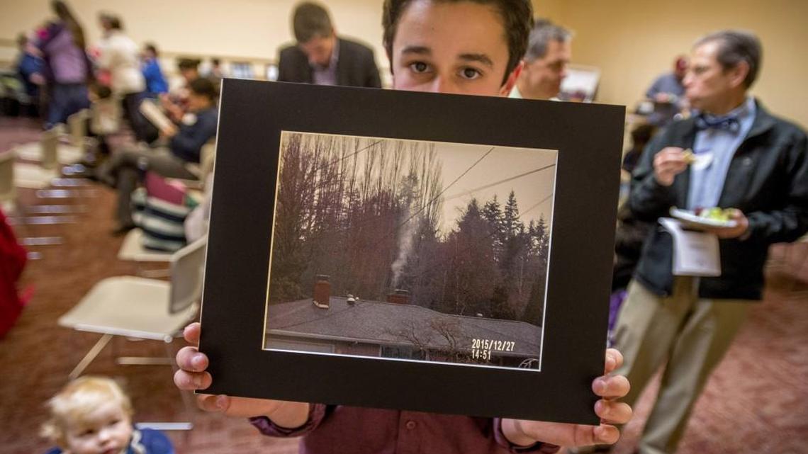 Will Handford shows one of his photos of smoke in a presentation at Grace Moore Library in Tacoma on Tuesday. It’s part of the Wood Smoke Photovoice project involving “youth citizen scientists” and sponsored by the University of Washington Tacoma.
