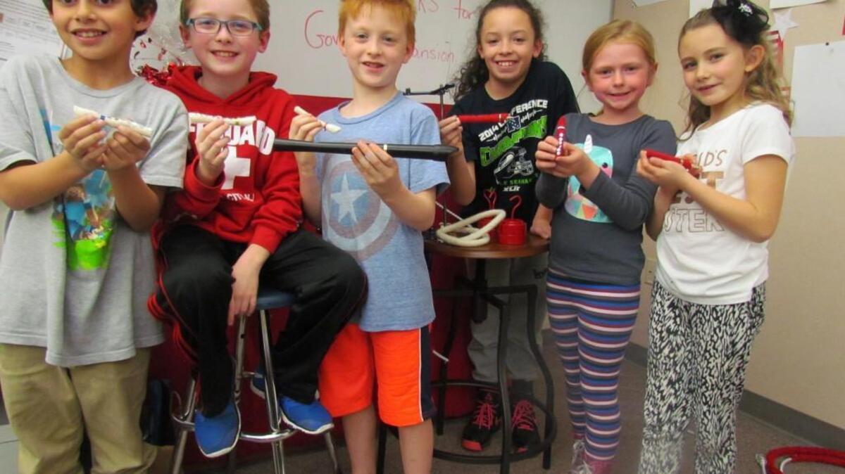 Students from Cherrydale Primary School show off ornaments created for the Governor’s Mansion Holiday Tree.
