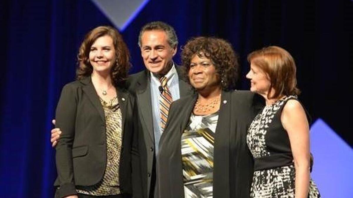 Superintendent Carla Santorno (center), after receiving the national Women in School Leadership award in Phoenix Friday. Pictured with her (from left) are fellow awardee Aimee Rainey, a principal in Florence, Ala.; Daniel Domenech, director of the national superintendents association and Mary Heuschel of the Bill and Melinda Gates Foundation, co-sponsor of the award.