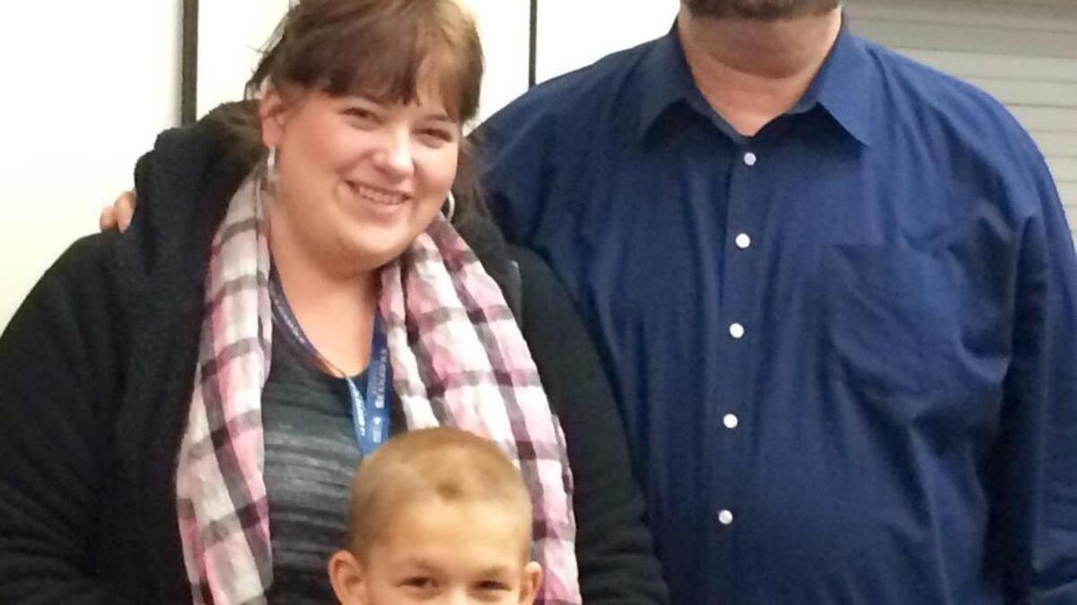 Gary Smith, wife Patience and son Phillip. Gary, a playground supervisor at Stanley Elementary, was recognized by the Tacoma School Board for keeping kids safe.