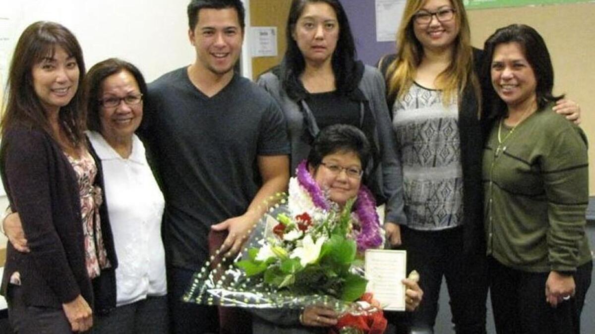 Sydney Sakamoto seated with her family