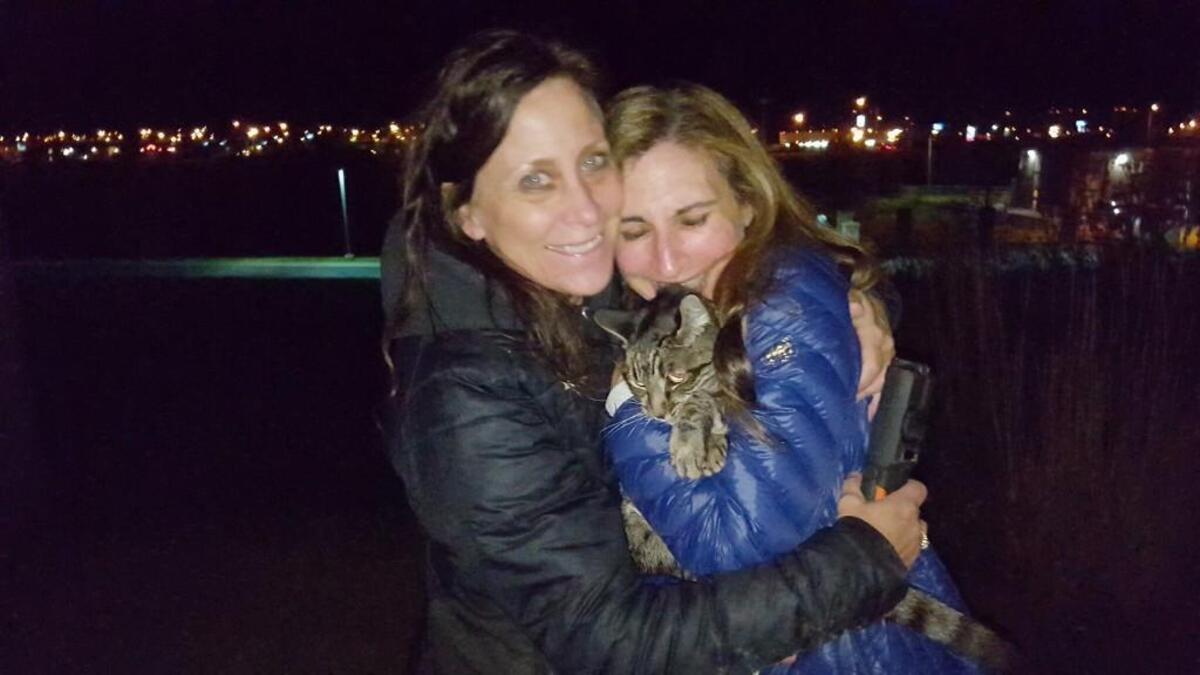 Theresa Froehlich, left, of Butte and Laura Carlson of Gig Harbor moments after they found Captain. The cat had been missing for 40 days.