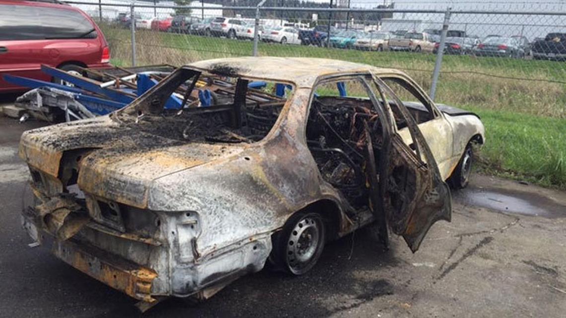 The driver of this car asked the man to use his truck to push the burning car off the highway.