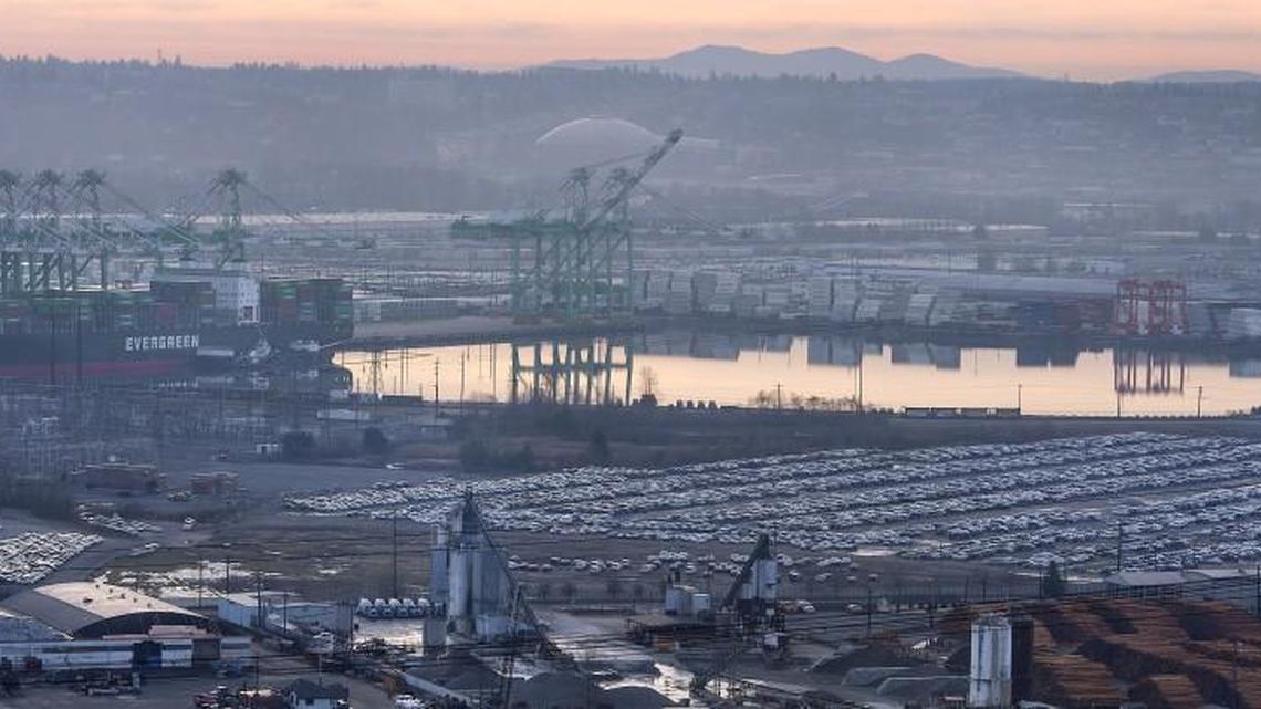 The 125-acre site of a proposed methanol production plant is temporarily being used by Auto Warehousing Company as a Foreign Trade Zone for imported cars. Tanker ships carrying the liquid to China would share the Blair Waterway with container ships accessing Pierce County Terminal, rear left. Photo taken in Tacoma on Tuesday, Feb. 9, 2016.