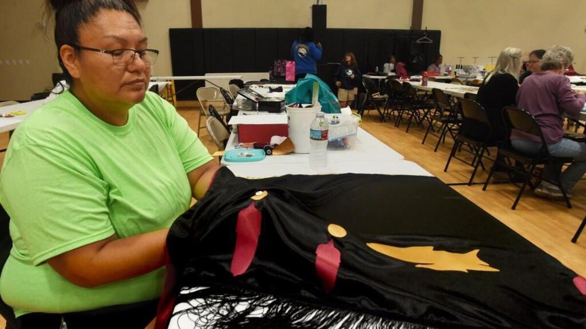 During a work session at the Billy Frank Community Center, volunteer Elizabeth John Vantiem finishes a lightweight shawl that will be worn by a ceremonial dancer at the 2016 Paddle to Nisqually. A tribal fisherman herself, Elizabeth will leave Tuesday for the Lummi reservation to participate as a Nisqually tribal canoe team member on the journey.