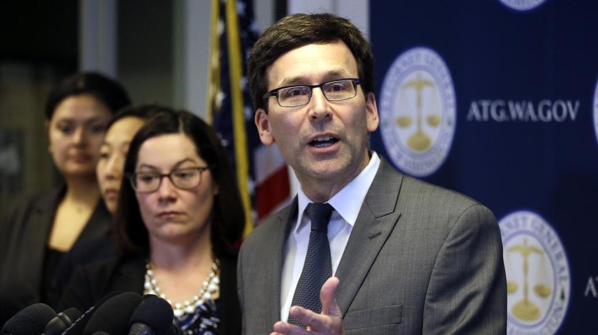 In this March 9, 2017, file photo, Washington State Attorney General Bob Ferguson speaks at a news conference about the state's response to President Trump's revised travel ban in Seattle, Wash. Ferguson has asked a federal judge for a Tuesday, March 14, 2017, hearing on the case.