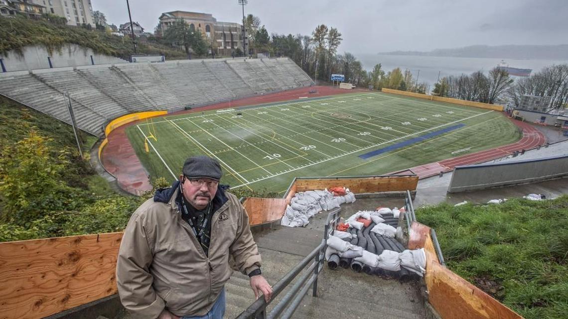 Tom Chalk, Tacoma Public Schools maintenance manager, has been working with the city of Tacoma and school district officials to find a solution for the recent flooding at the Stadium Bowl. Chalk stands on the stairs leading to Stadium Bowl, where the district installed a temporary plywood wall to deflect torrents of water away from a hillside and the field.