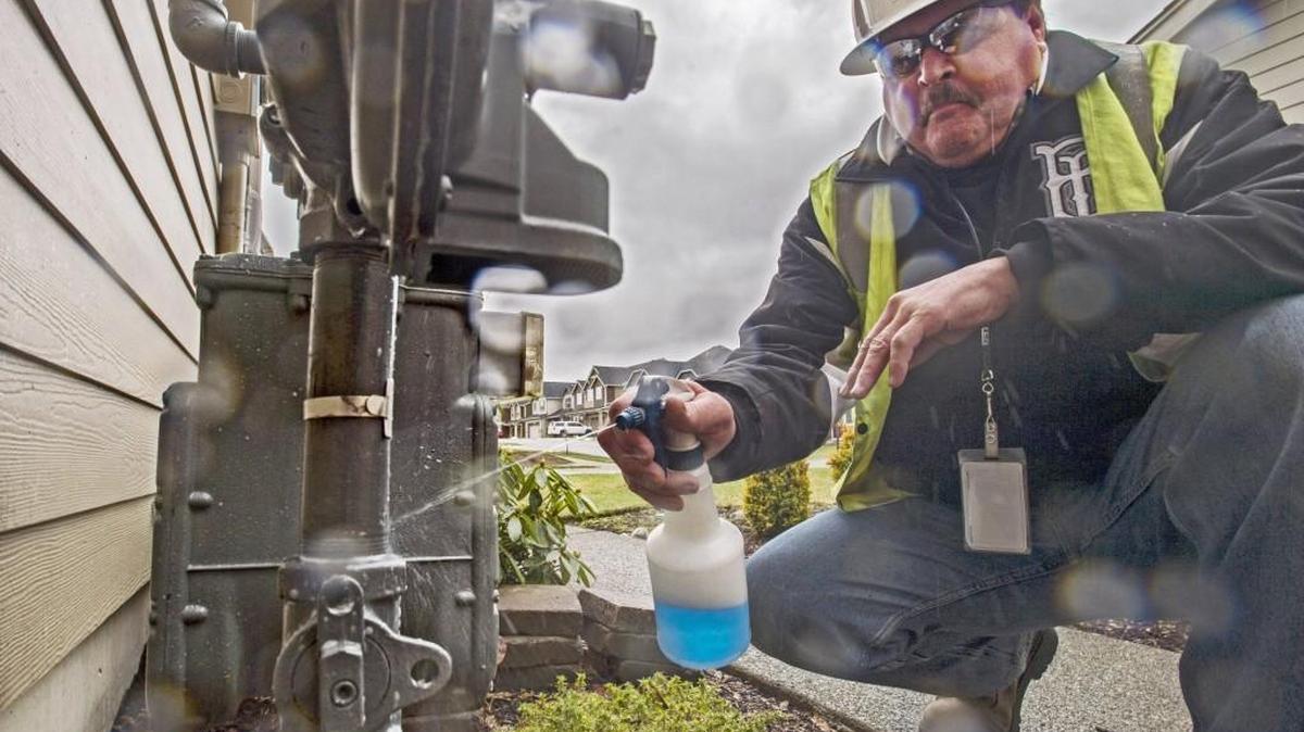 John Hander, supervisor of a Gas First Response Team from Puget Sound Energy, sprays a soap solution on the joint where a supply pipe connects to the gas meter of a home in Tehaleh, February 10, 2017. If bubbles are continuously produced afterward, that reveals a leak. Puget Sound Energy is including scratch-and-sniff brochures with bills in an effort to help customers identify natural gas leaks.