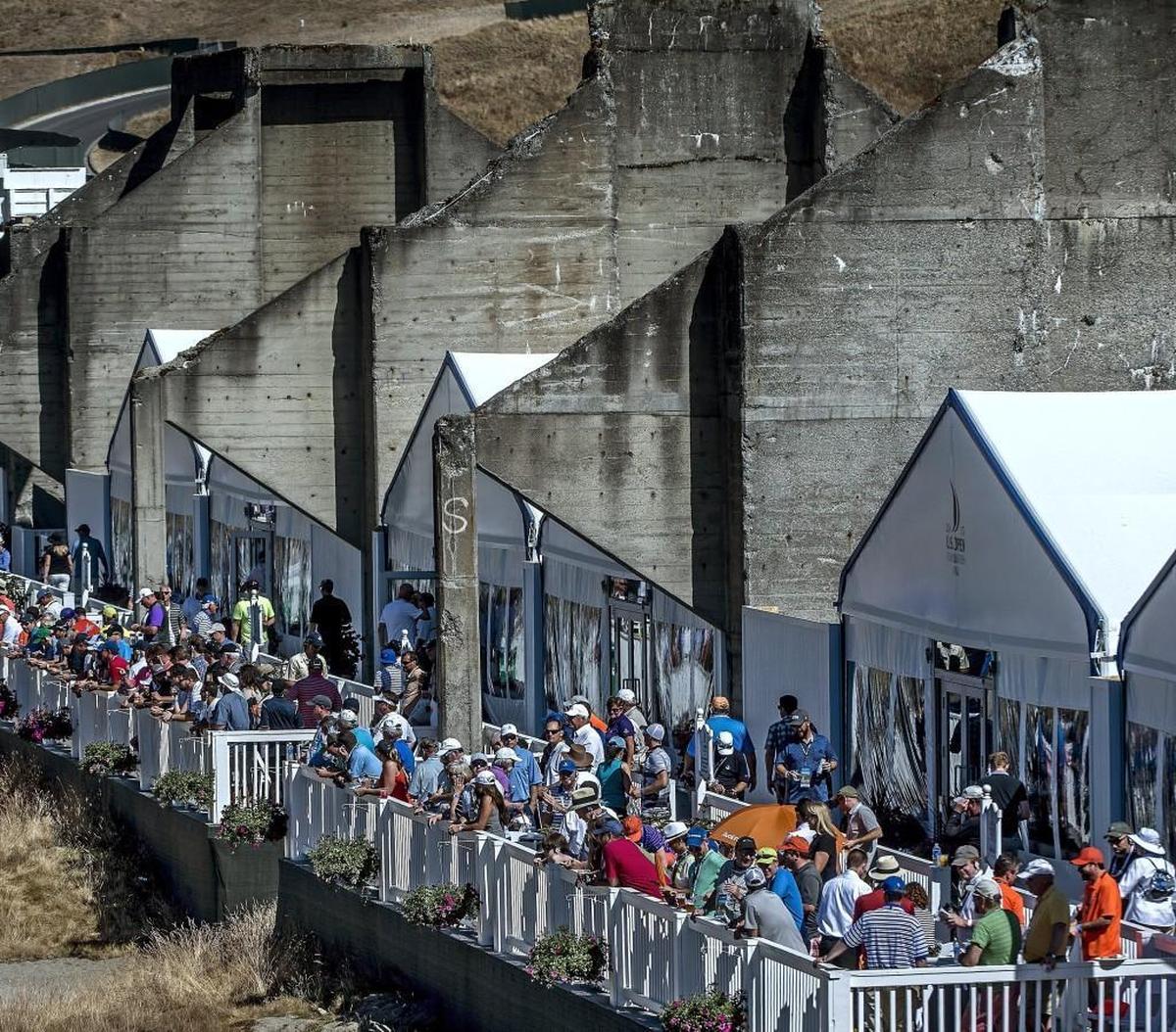 Fans enjoy the action from suites built into the remnants of the sorting bins of what used to be a sand and gravel mine on the fourth day of the tournament at the 115th U.S. Open at Chambers Bay, Sunday, June 21, 2015. Leaders fear the proposed master plan for the golf course will threaten the chances of attracting future big-ticket events.