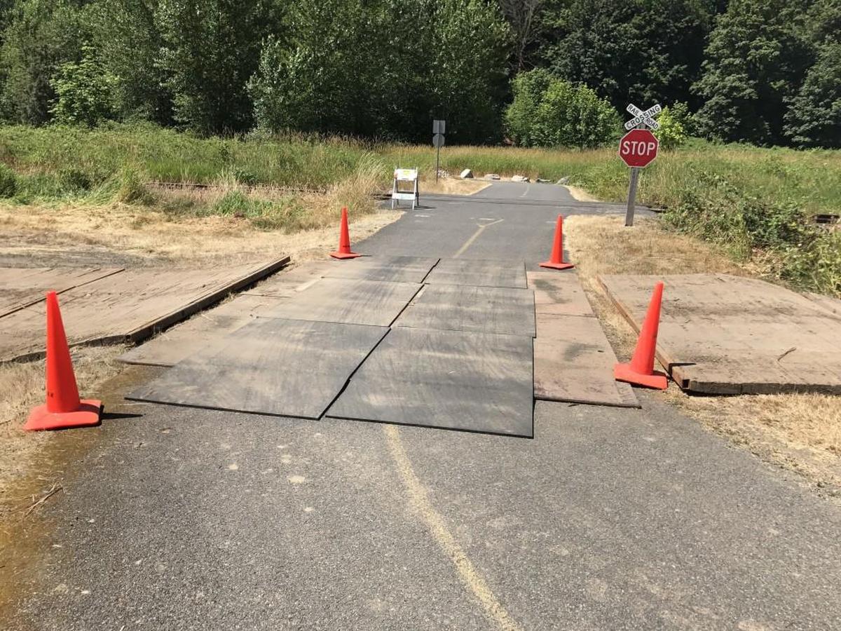 Large mats cover a section of the Foothills Trail between two sharp turns near Puyallup. Puget Sound Energy is working to install a transmission line. A 1.4-mile section of the trail will be closed August 1-October 31.