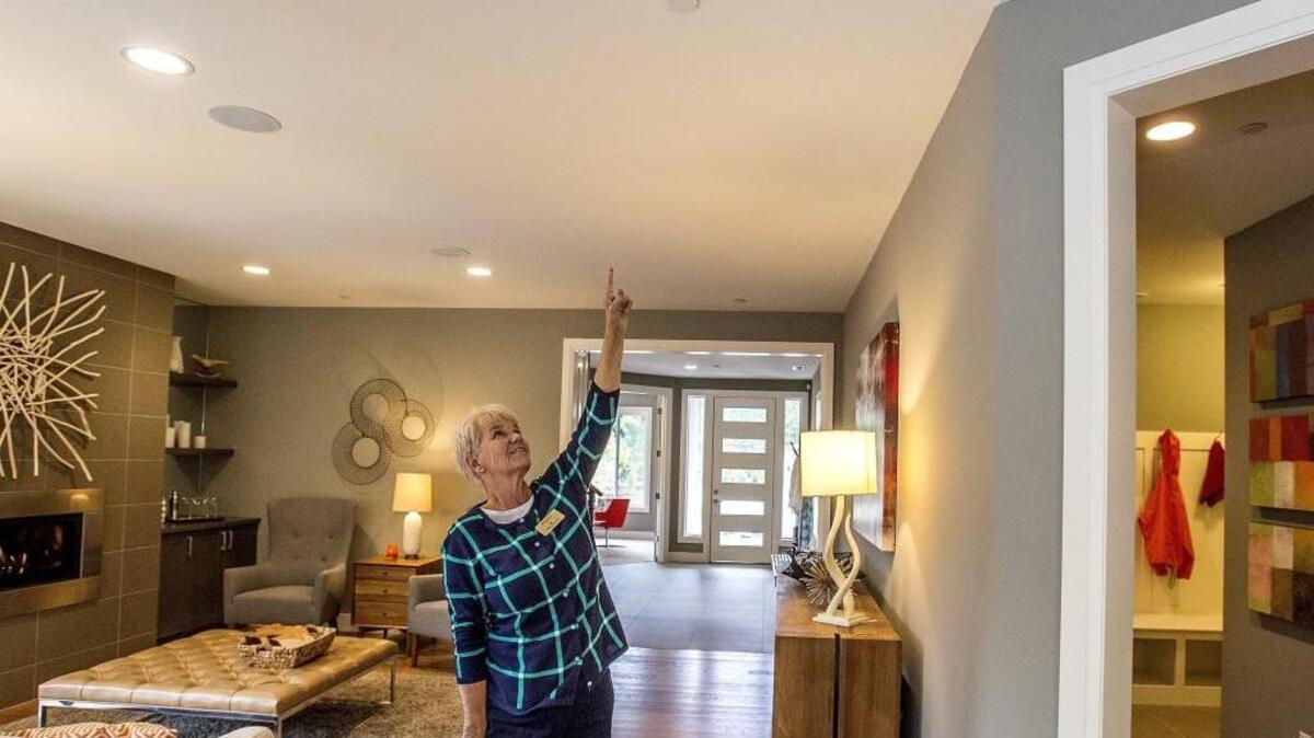 Realtor Molly Taylor points to one of the sprinkler heads inside a model home at the Bellasara housing project in Gig Harbor on Friday. Rush Residential installed the sprinklers in the new homes because the water flow isn’t strong enough to withstand a “mega” fire, but don’t normally build homes with fire sprinklers. Gig Harbor is looking to require all homes built after Jan. 1, 2017, to have a fire sprinkler system. Master Builders Association of Pierce County says it’s too expensive for builders/contractors and the cost will be passed on to buyers.