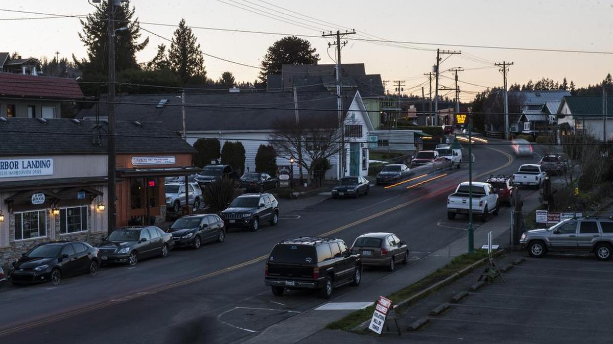 Cars drive along Harborview Drive at dusk in Gig HarborFeb. 22. Some Gig Harbor residents want to see earlier closing times for businesses in the Millville area.