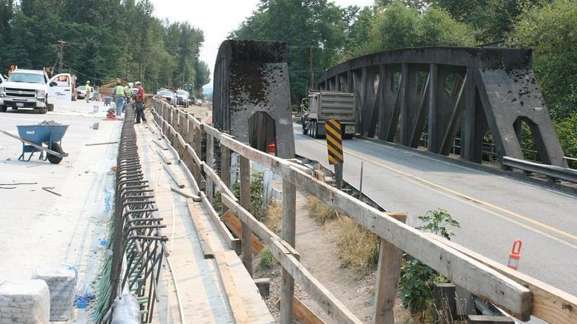 
The new bridge, left, over the Puyallup River takes shape north of Orting next to the 1934 McMillin Bridge. Crews finished connecting state Route 162 to the new bridge Sunday morning. 
